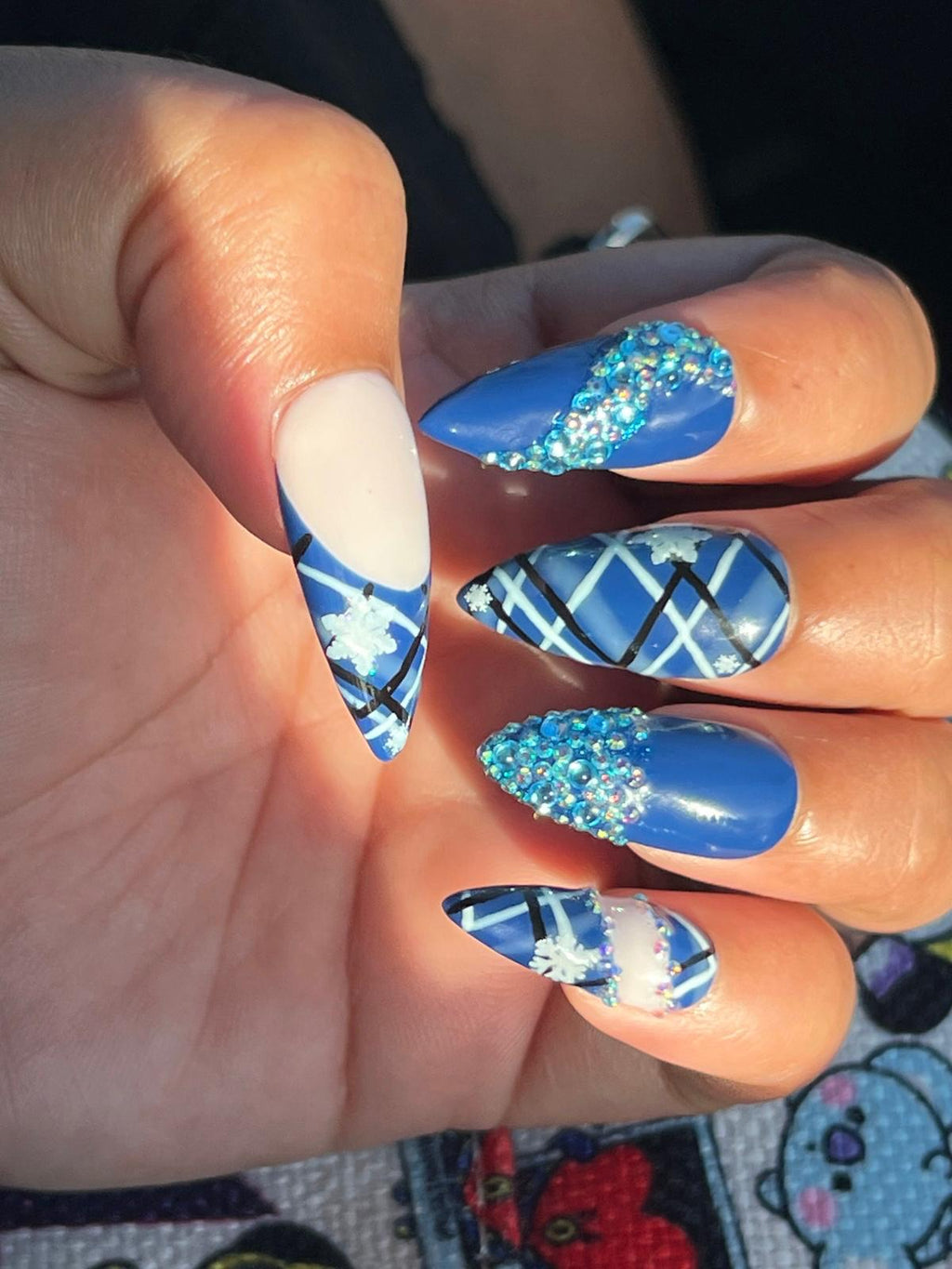 Medium Almond with blue and nude bedazzled Christmas themed nails